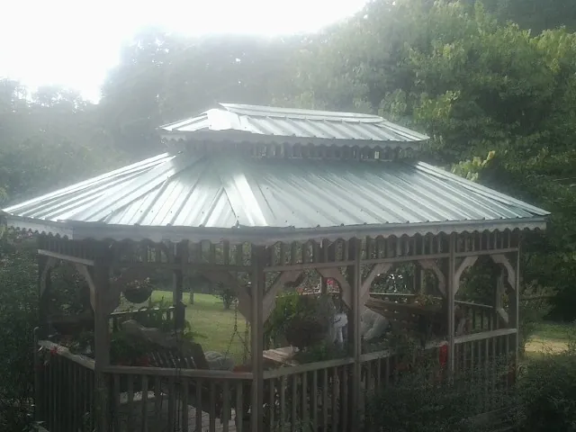 Two tier green metal roof on a garden gazebo in Shelby